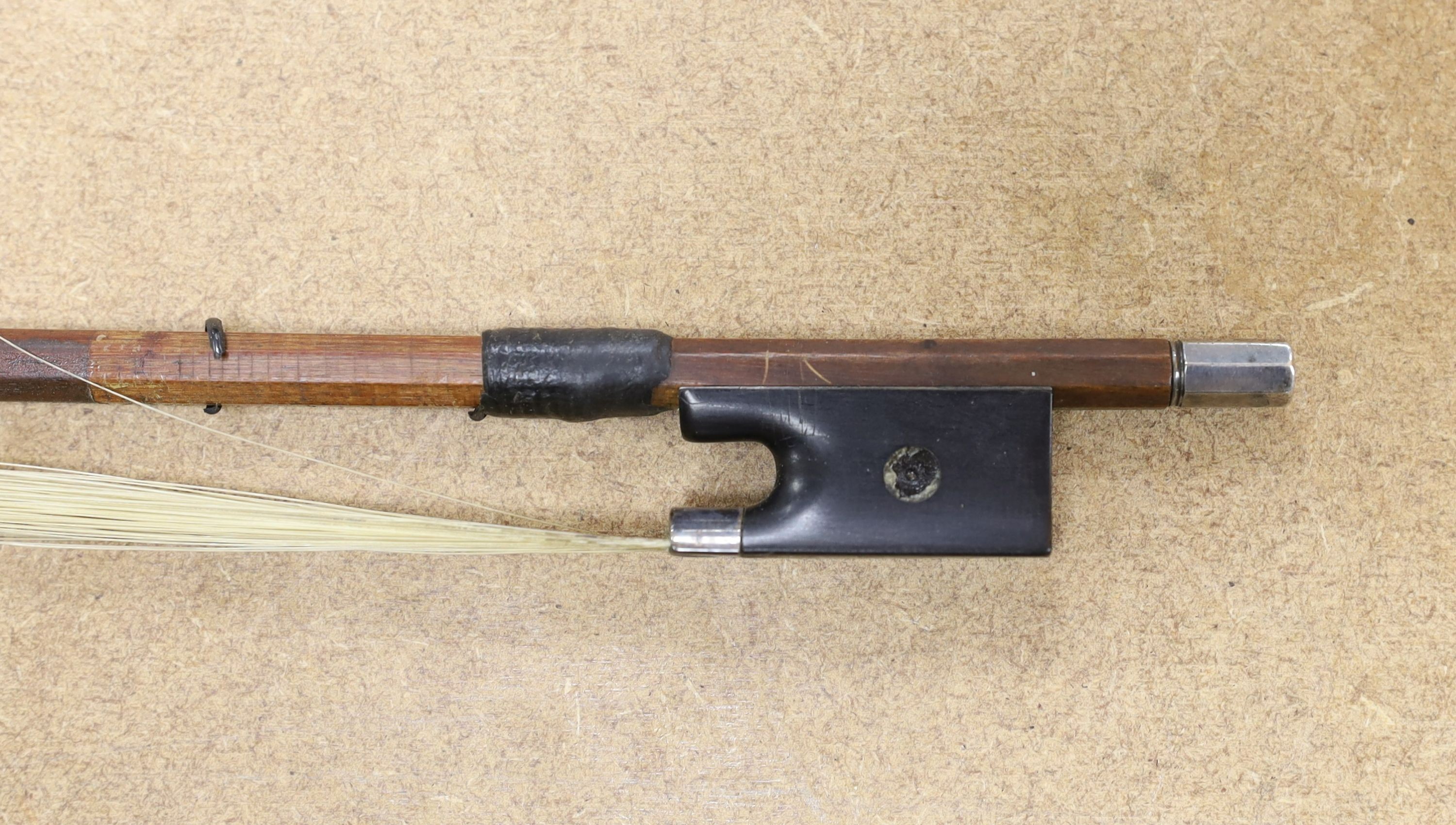 A 19th century violin with 14 inch 2 piece back, unlabelled, cased with silver mounted bow.